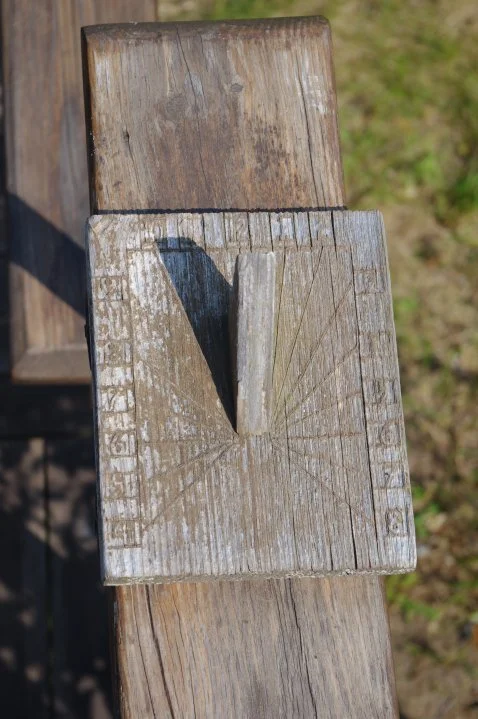 A sundial in the grass